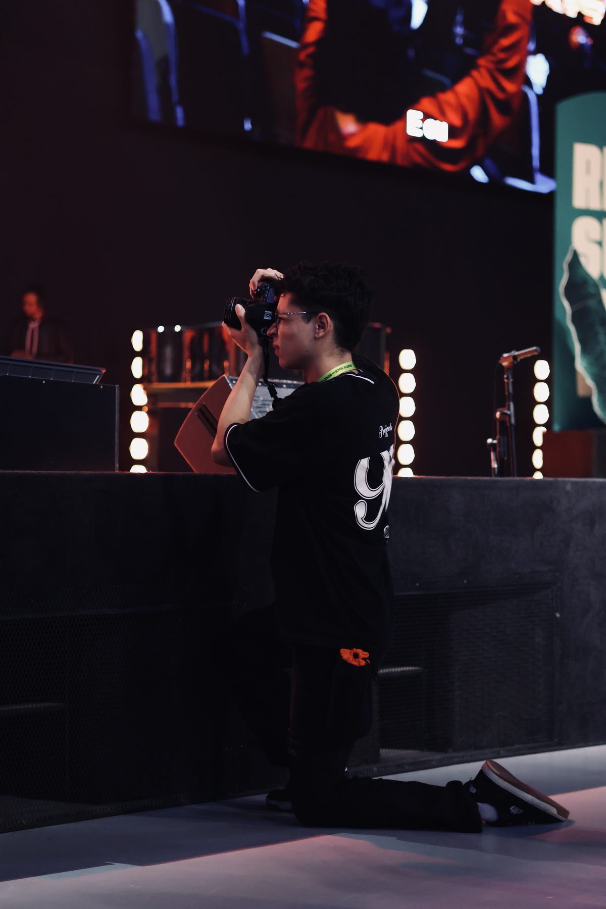 Eu mesmo, ajoelhado no palco, fotografando o show com a câmera